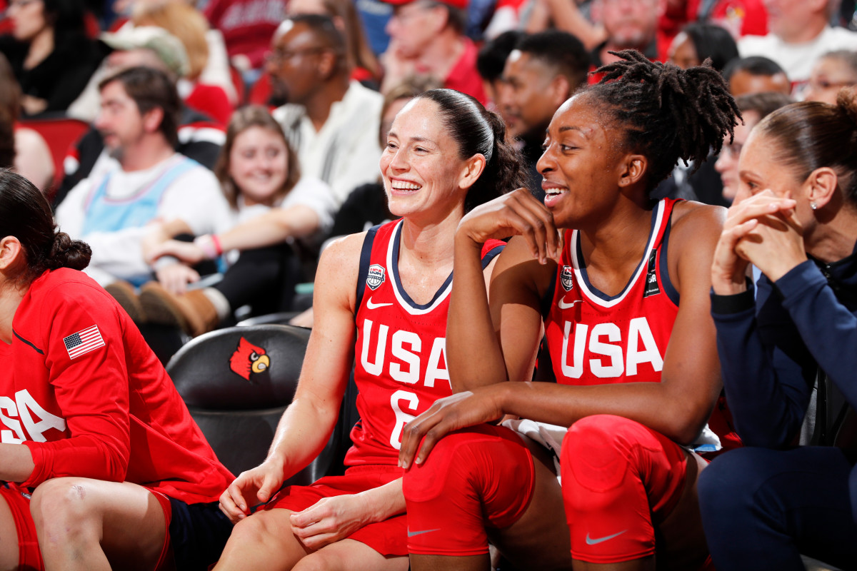 Sue Bird and Nneka Ogwumike smiling in red Team USA jerseys
